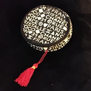 CHANEL Monochrome Round Pouch with Vibrant Red Tassel